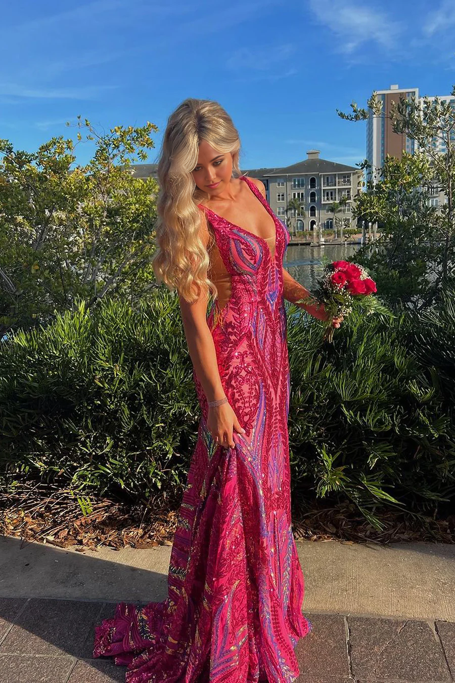 Fuchsia sequin mermaid V-neck prom dress.