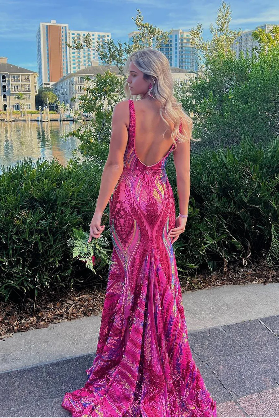 Back view of fuchsia sequin mermaid V-neck evening gown.