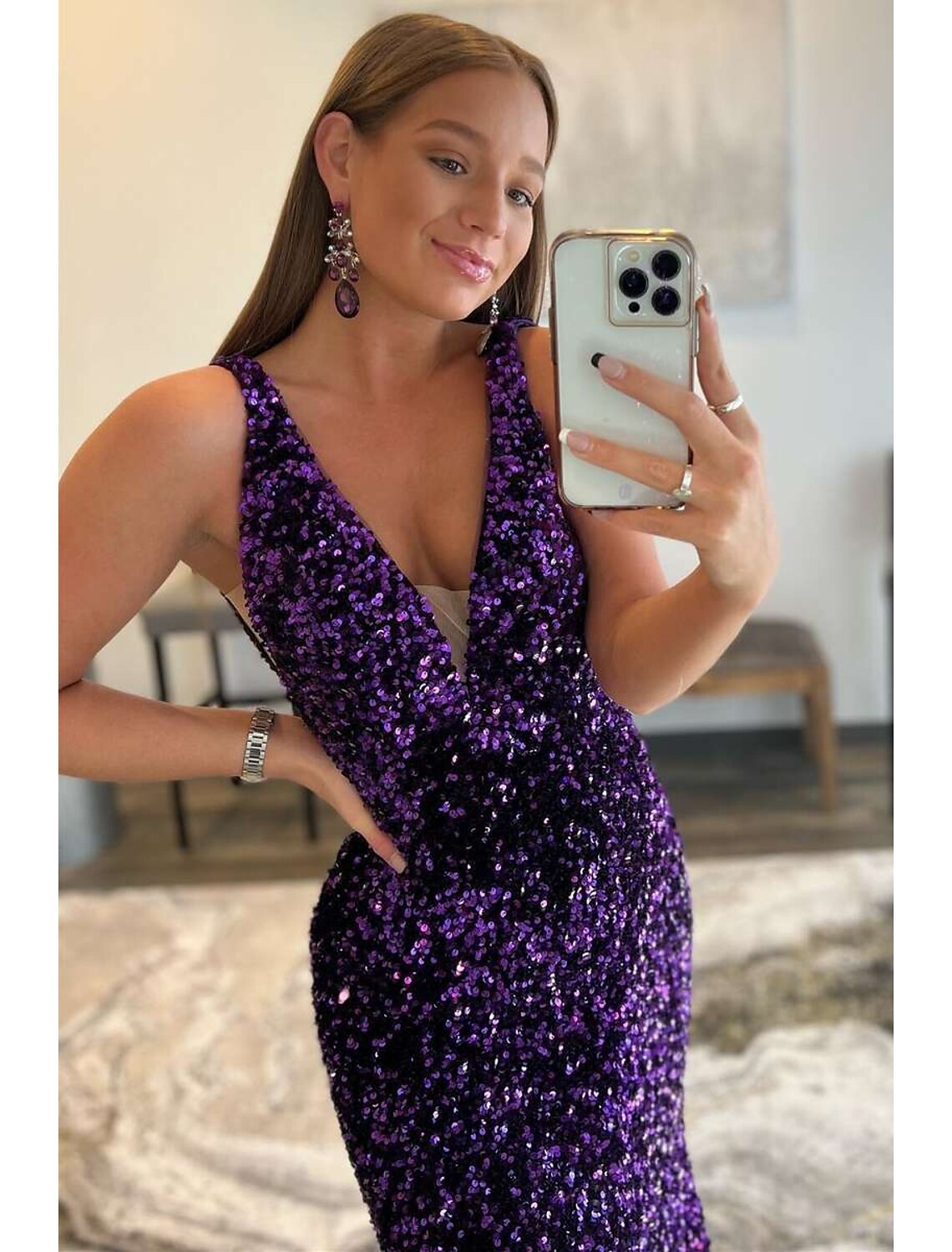 Side view of the elegant sequined mermaid gown with a V-neckline.