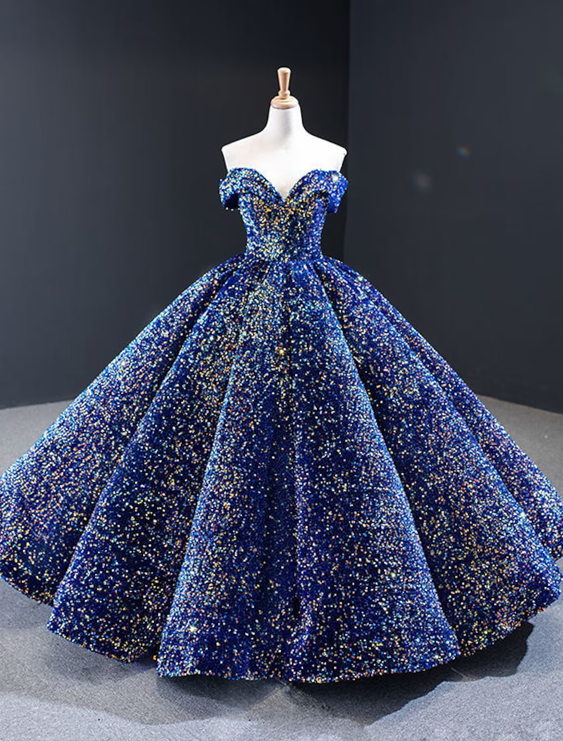 Model in a sparkling off-shoulder quinceanera ball gown.