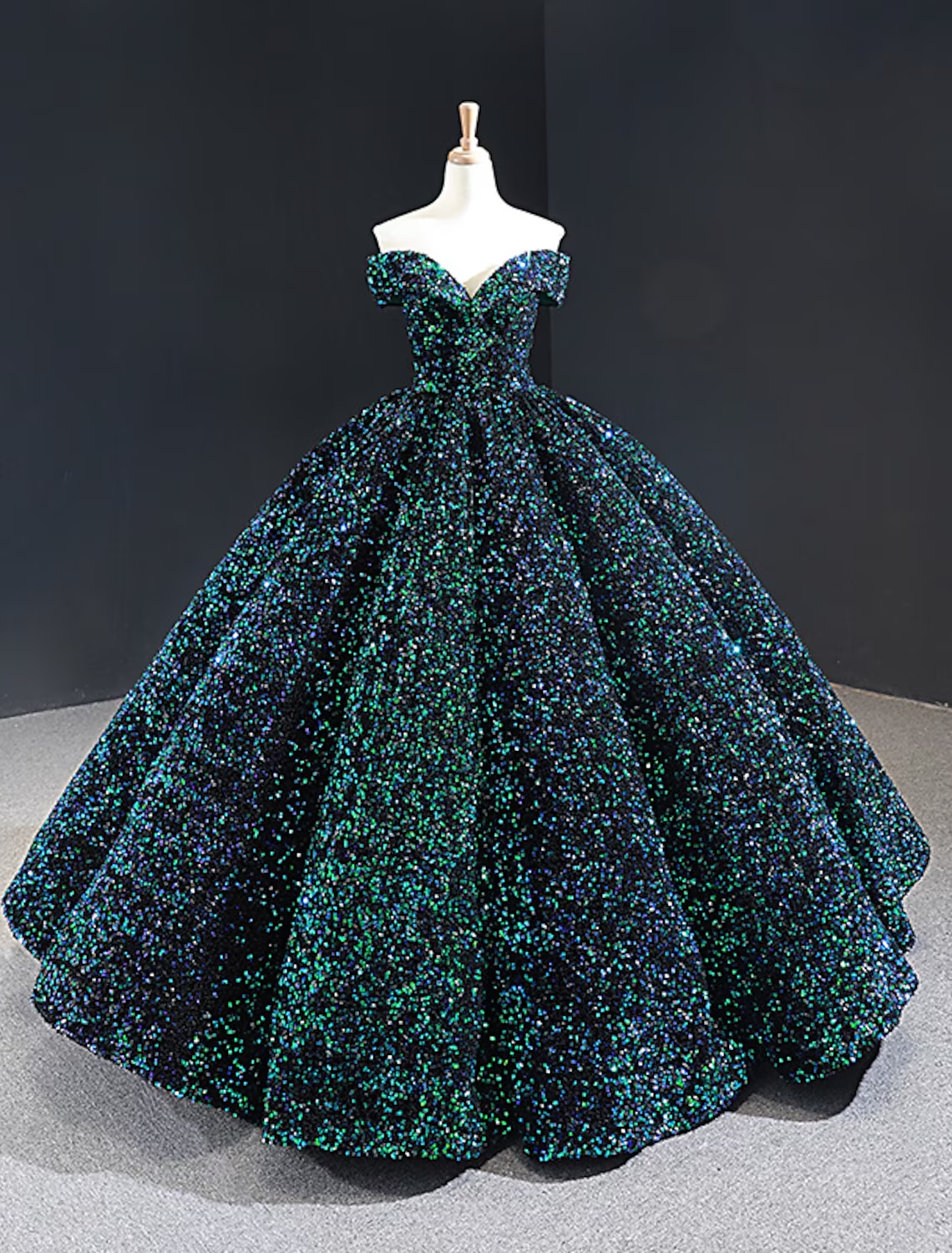 Full view of a sequined formal evening dress with a flowing pleated skirt.