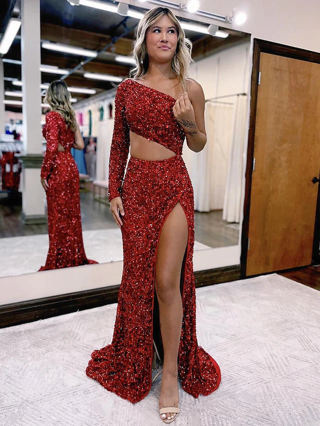 Dazzling sequined mermaid prom dress with one long sleeve and a high slit.