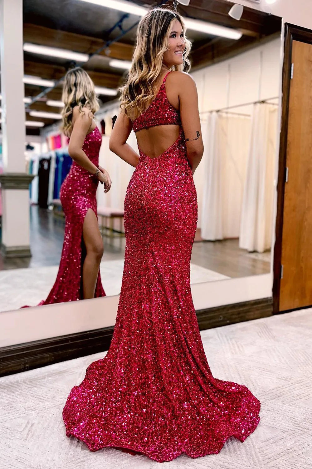 Back view of the elegant one-shoulder sequin mermaid gown.
