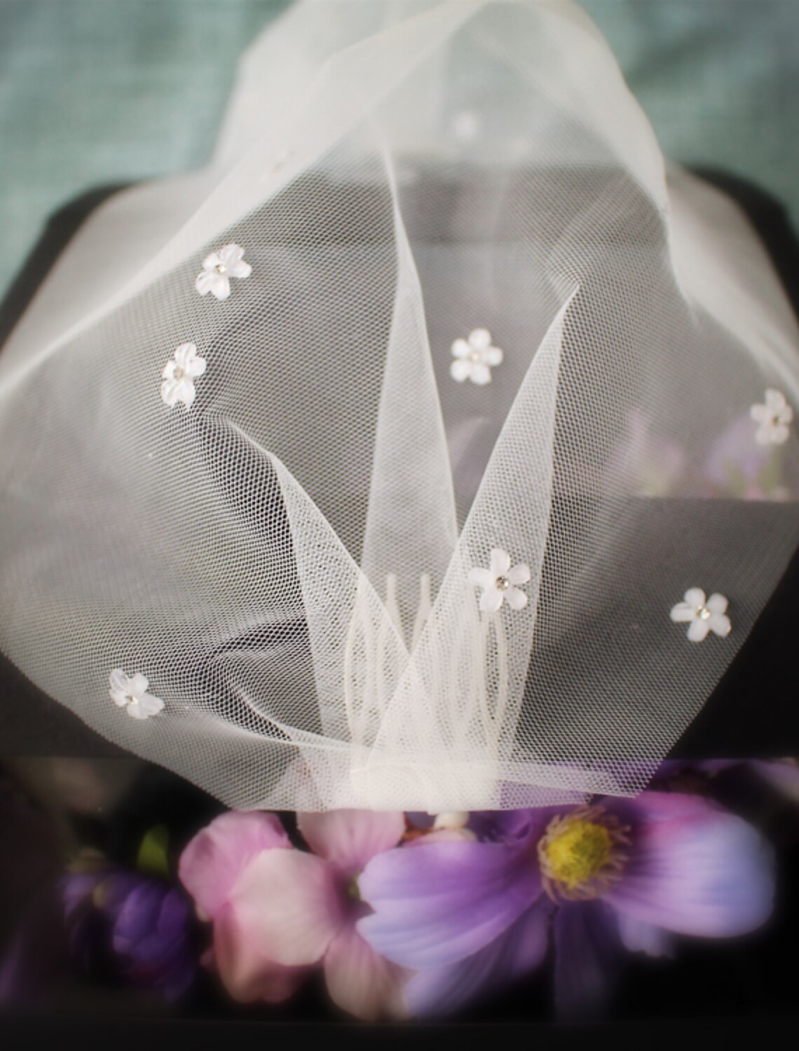 Close-up of the rhinestone and tulle details on a one-tier wedding veil.
