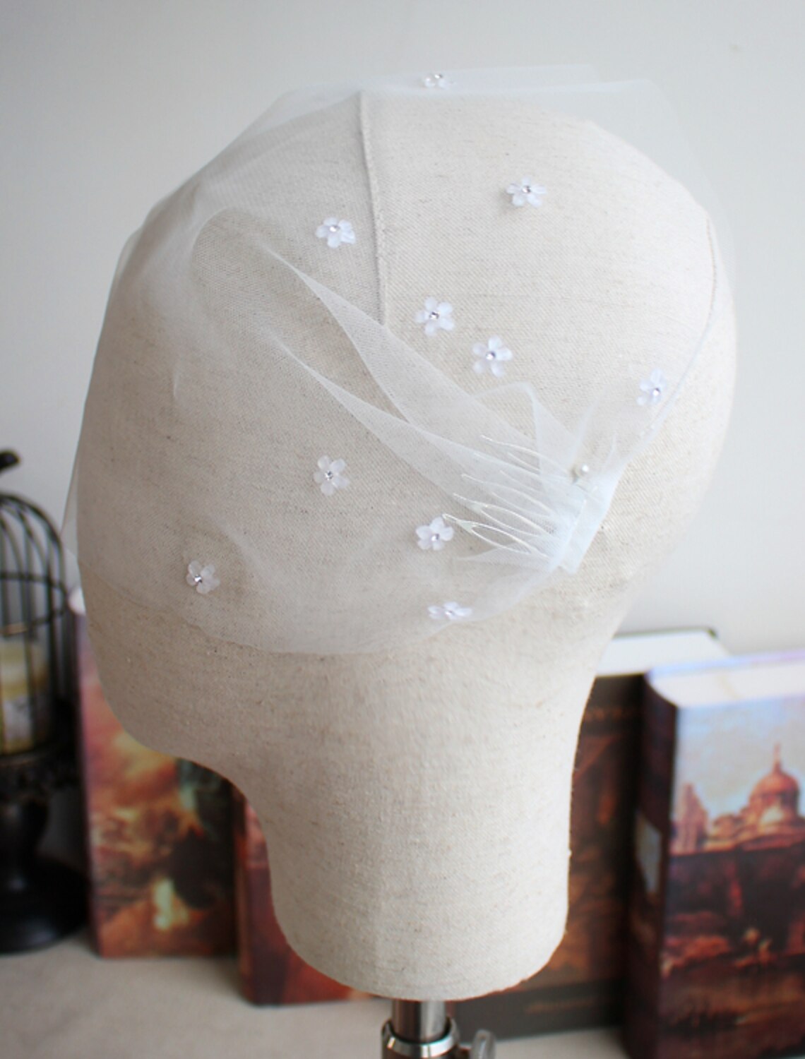 Side view of a bride wearing a short, elegant wedding veil with sparkling embellishments.