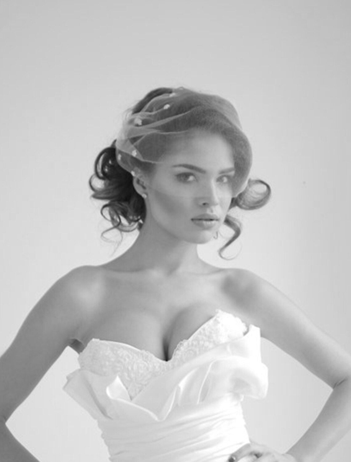 Back view of a one-tier wedding veil showing its delicate tulle and rhinestone accents.