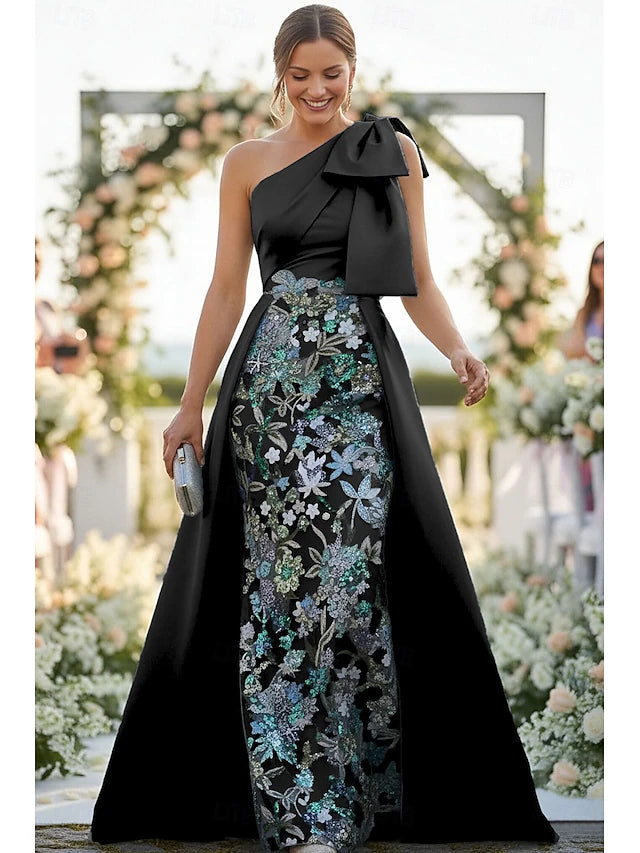 Back view of the emerald green sequin gown, showcasing the sheer mesh.