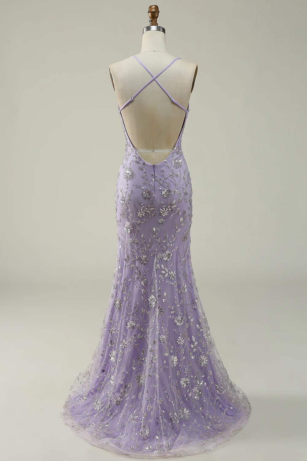 Side view of a woman in a purple sequin mermaid gown, showcasing the elegant silhouette.
