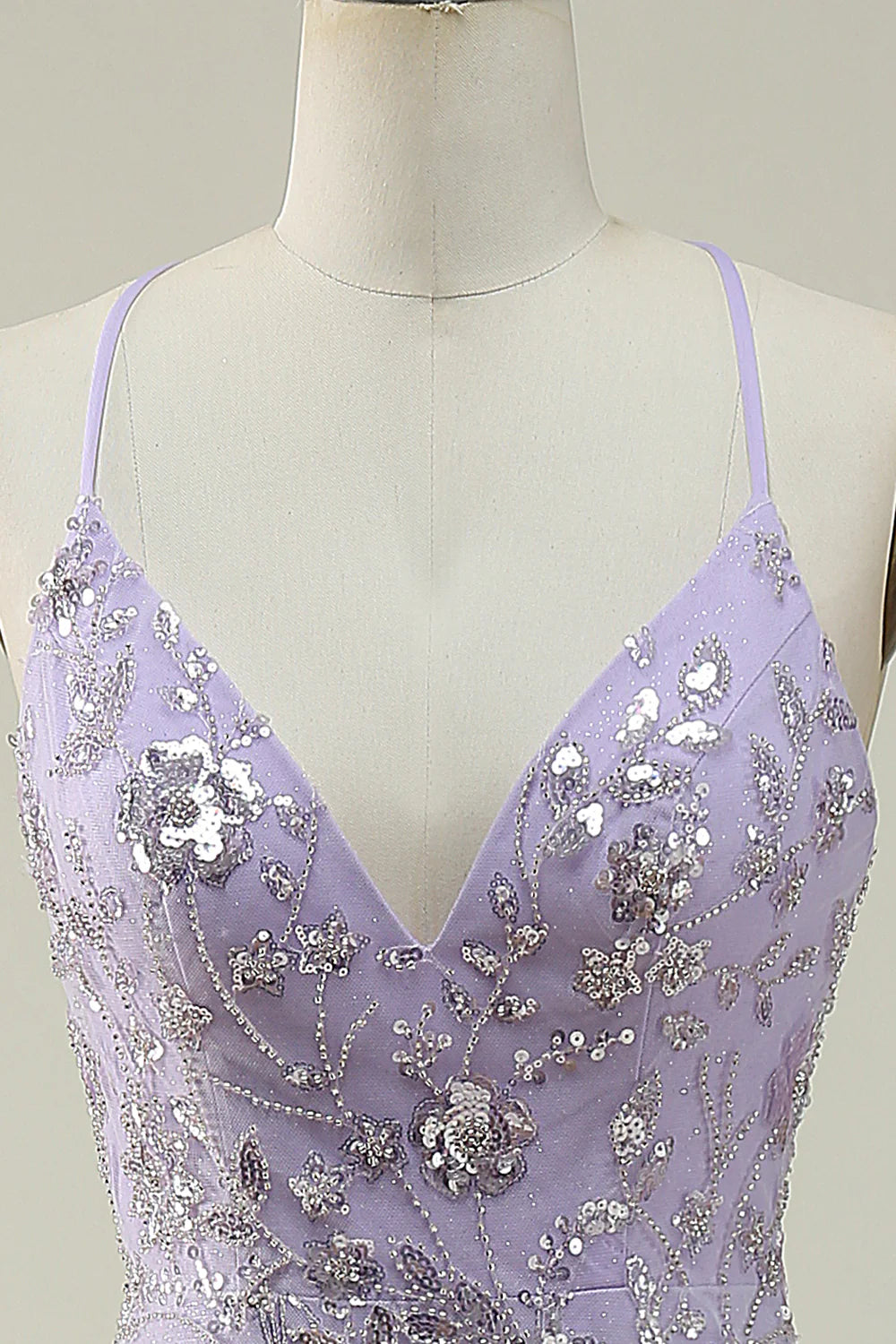 Close-up of the sequin fabric and the V-neckline of the purple mermaid dress.