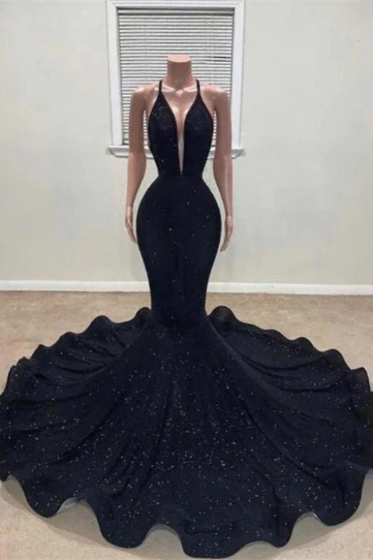 Woman in a dazzling sequined halter mermaid maxi prom gown.