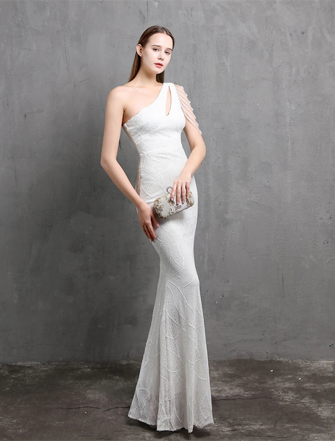 Elegant woman posing in a one-shoulder sequined formal gown.