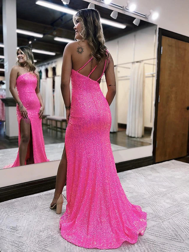 Back view of a model in a sequined one-shoulder mermaid prom dress, highlighting the backless design.