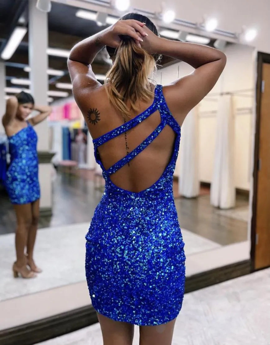 Back view of a woman in a shimmering one-shoulder sequin homecoming dress.