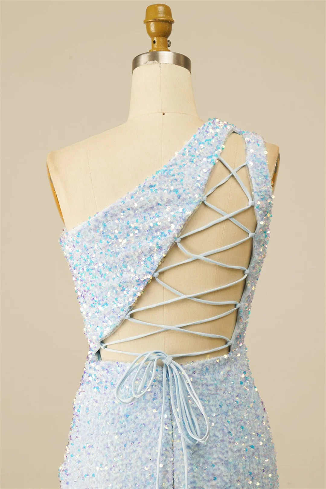 Side view of a shimmering sequin sheath dress, one-shoulder style.