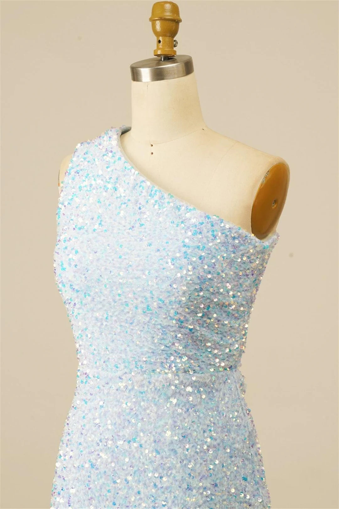 Close-up of the sequin fabric and one-shoulder design on a dress.