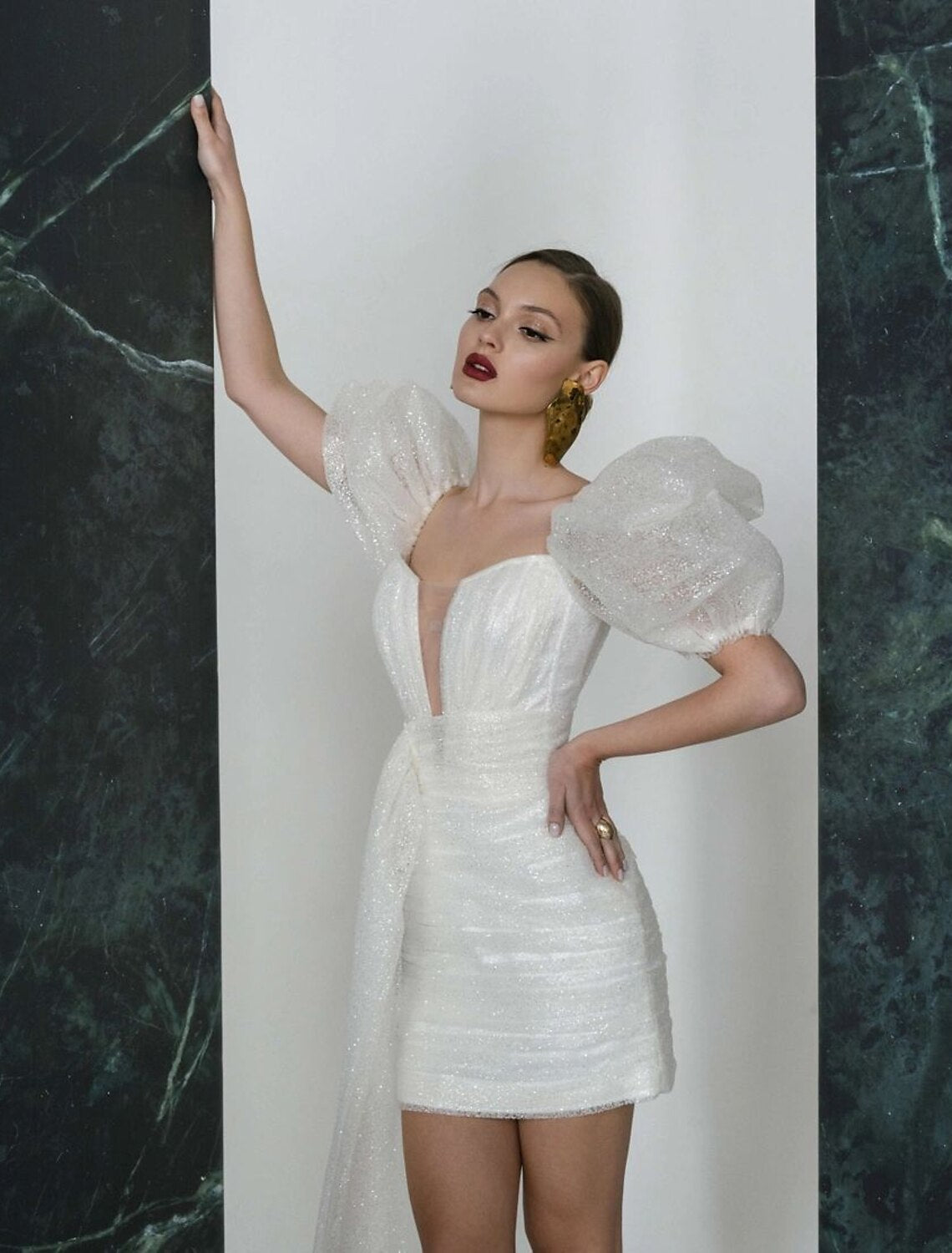 Dazzling white sequined mini wedding dress with V-neck and short sleeves.