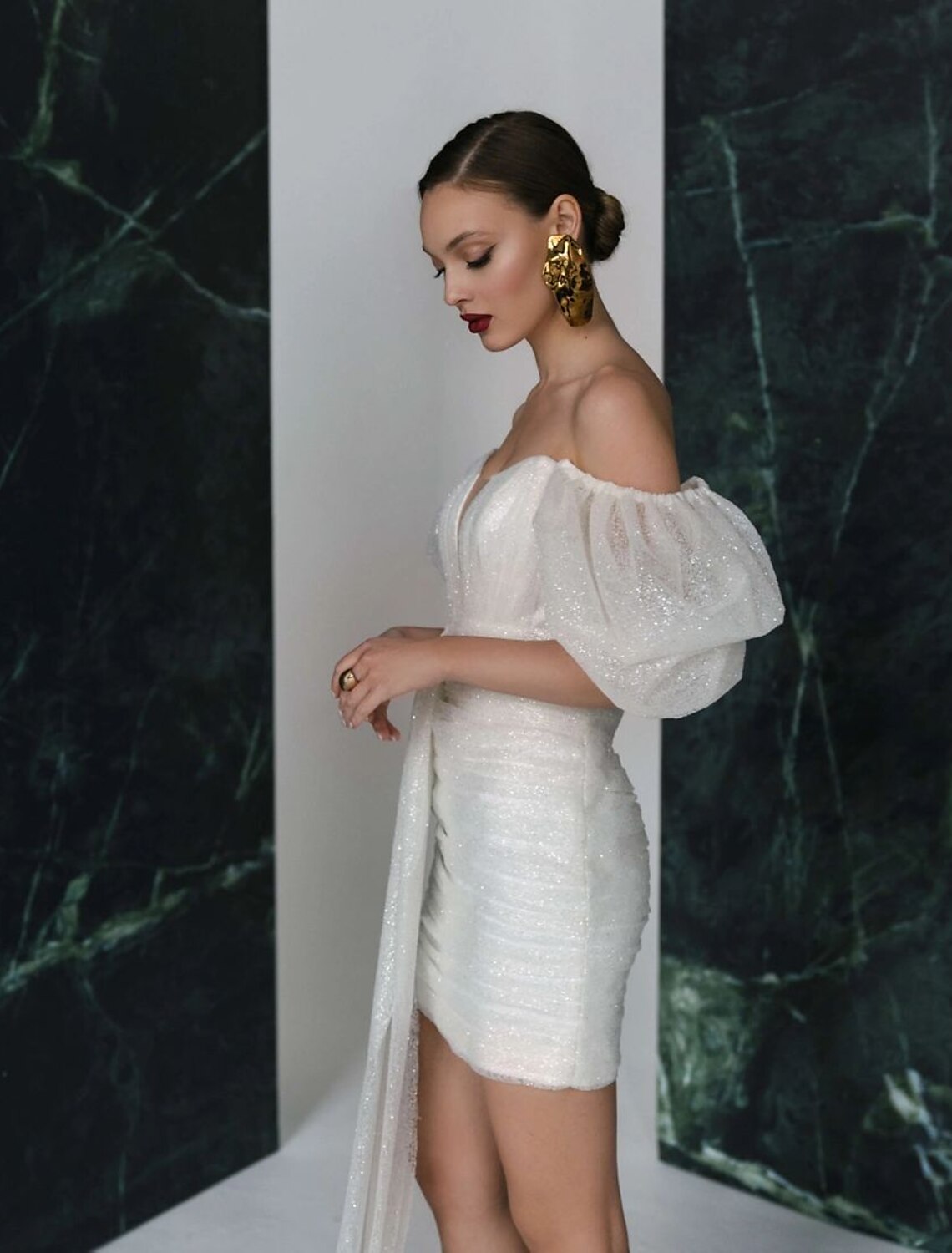 Side view of sparkling white V-neck short sleeve reception dress.