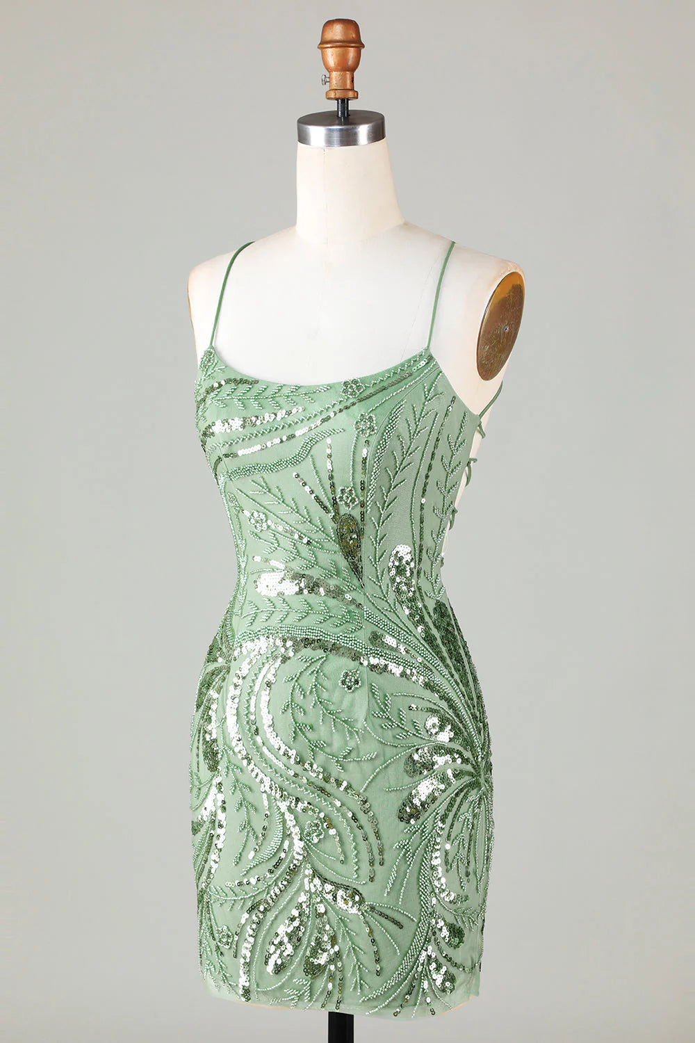 Front view of a model wearing a sparkly beaded backless sequin short homecoming dress.