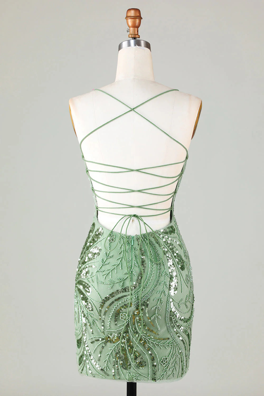 Back view of a model wearing a sparkly beaded backless sequin short homecoming dress, showing back detail.