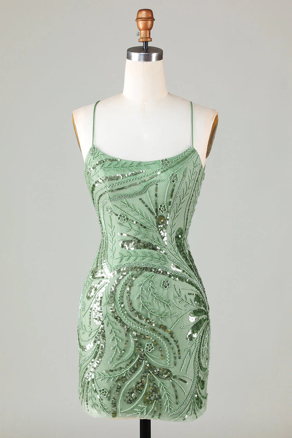 Side view of a model wearing a sparkly beaded backless sequin short homecoming dress.