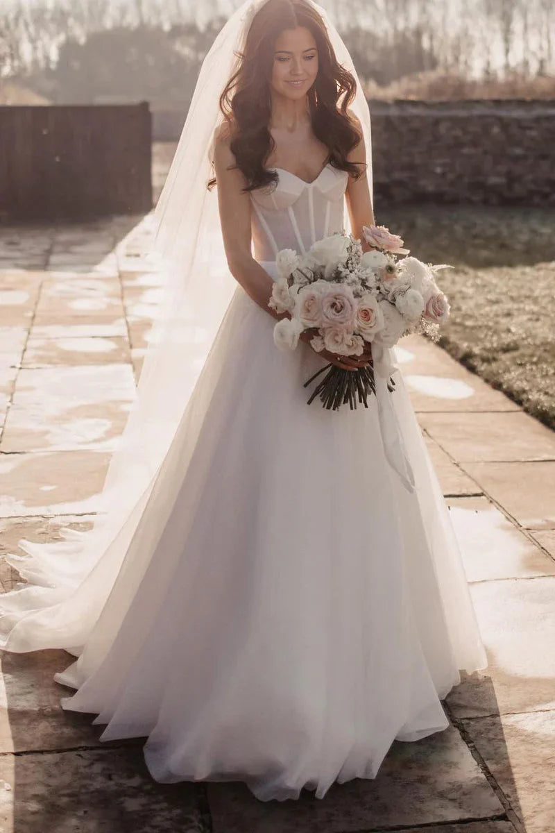 Full view of a model wearing a sparkly glitter A-line sweetheart tulle wedding dress.