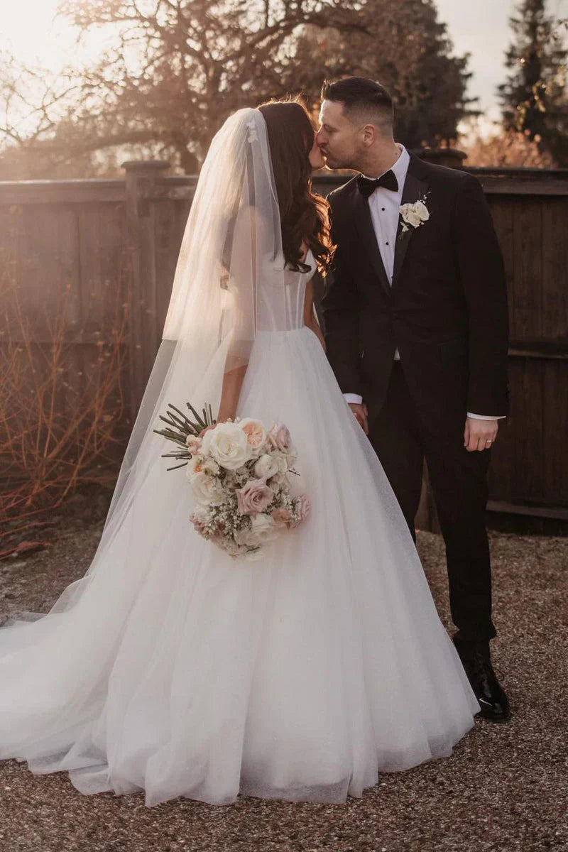 Side view of a sparkly glitter A-line sweetheart tulle wedding dress.