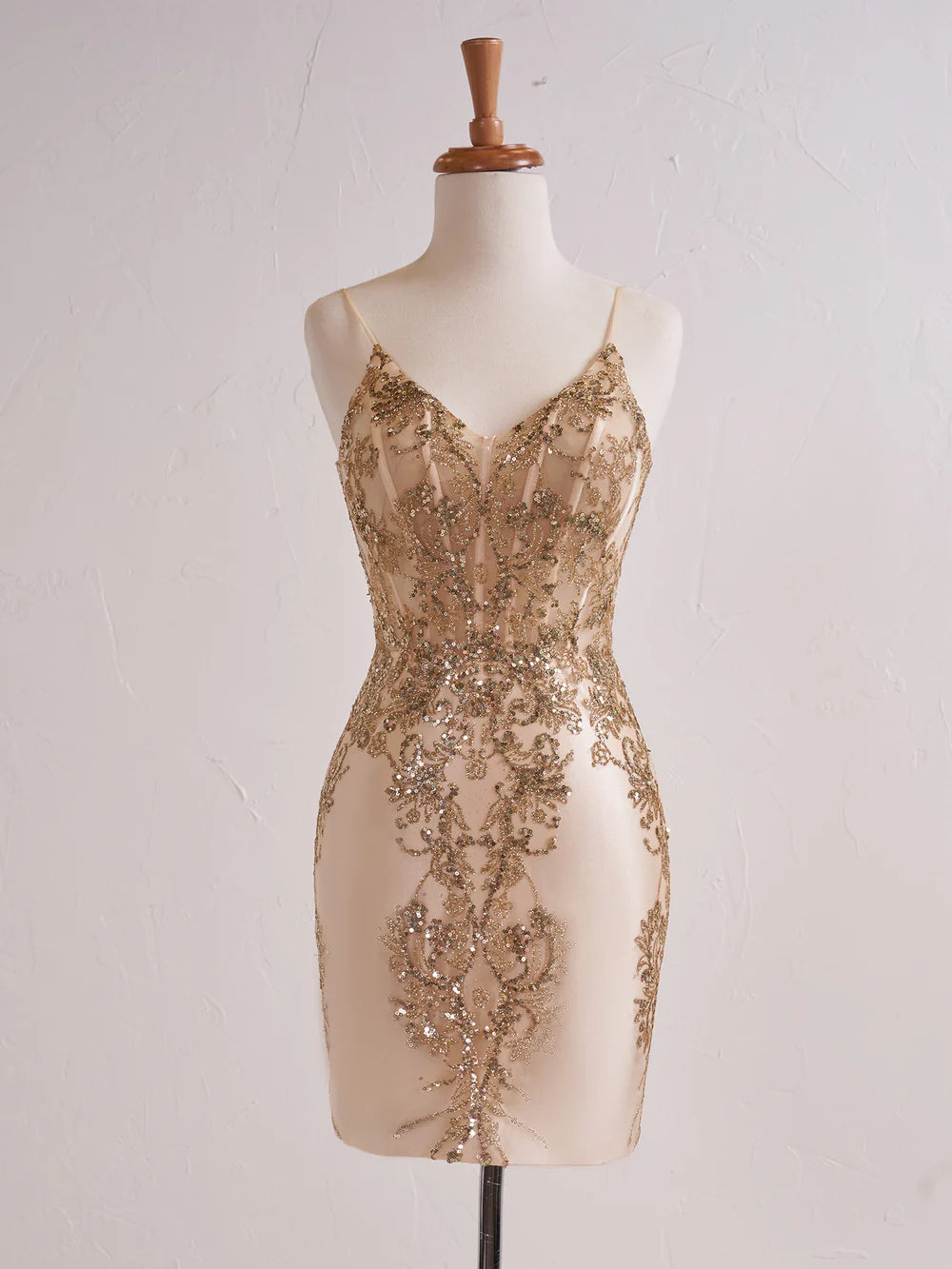 Model wearing a dazzling strapless short sequin prom dress.