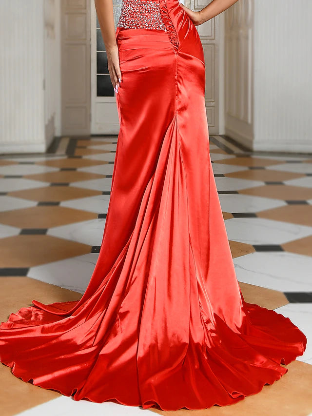 Woman posing in the elegant strapless sequin gown.