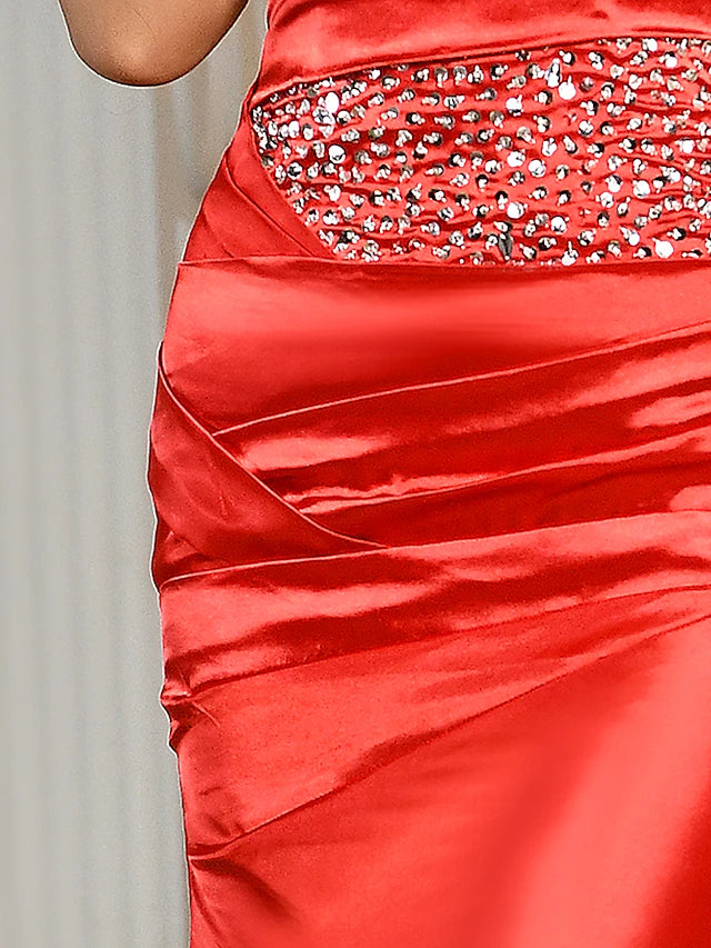 Detailed view of the charmeuse fabric and sequin embellishments.