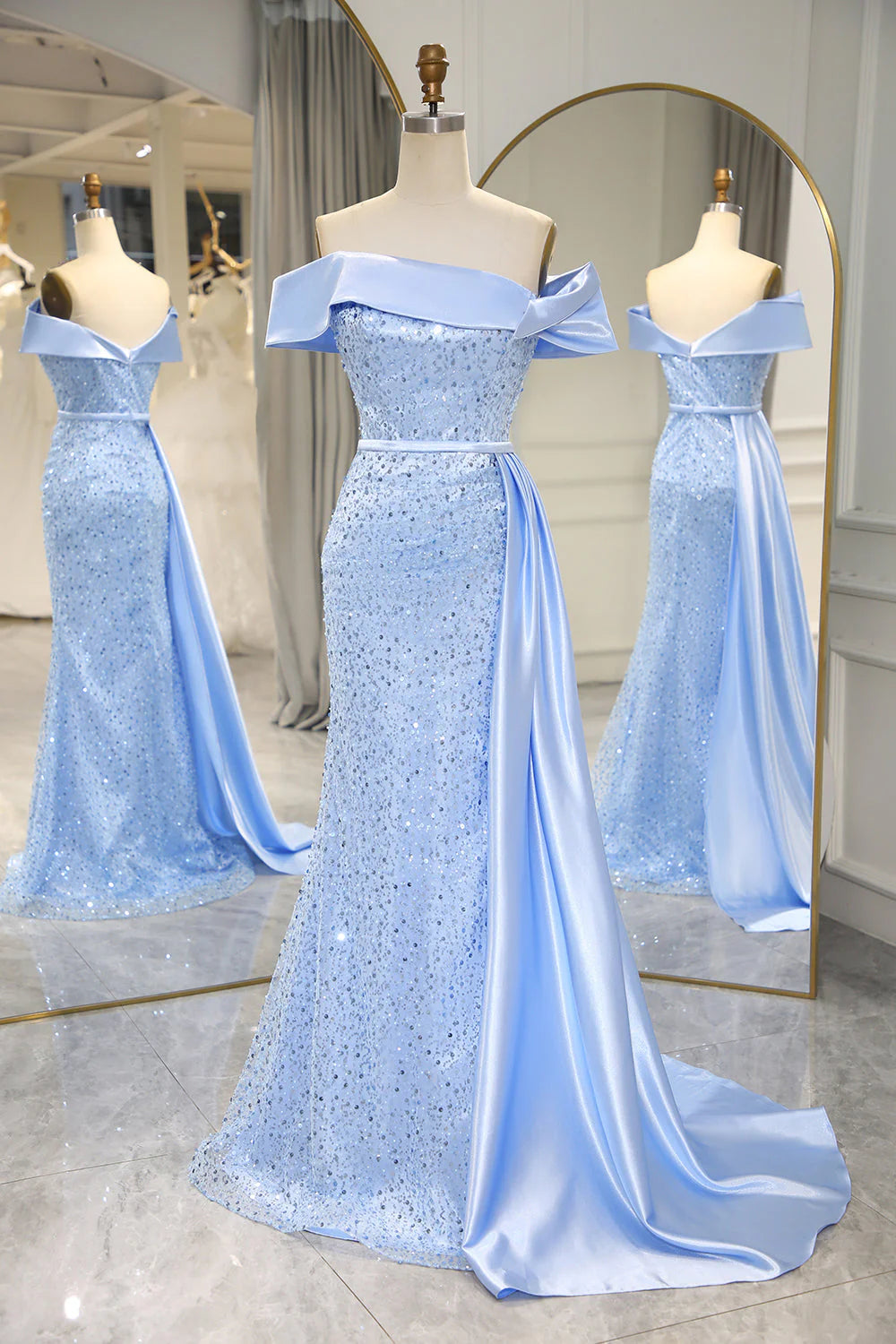 Model wearing a dazzling light blue sequined prom dress with a high slit, posing elegantly.