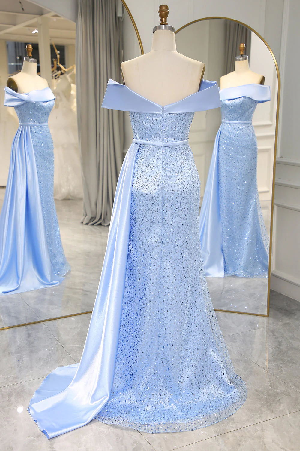 Back view of the light blue sequined prom dress, showcasing the flowing train.