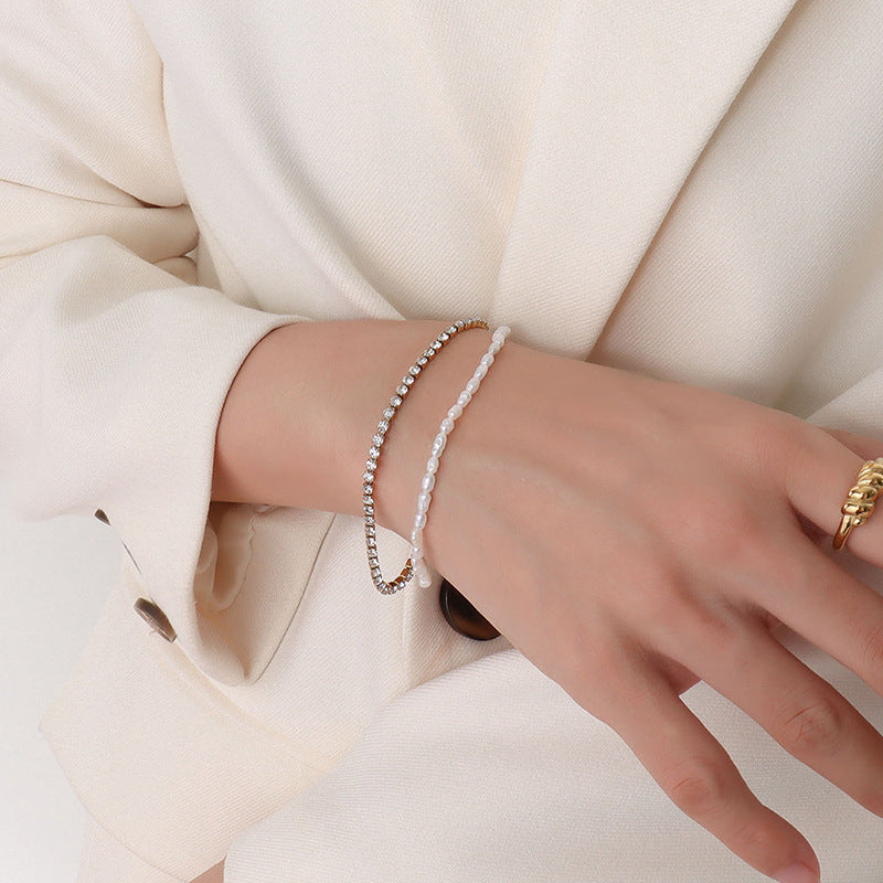 Detailed view of the freshwater pearls and zircon on the double-layered chain bracelet.