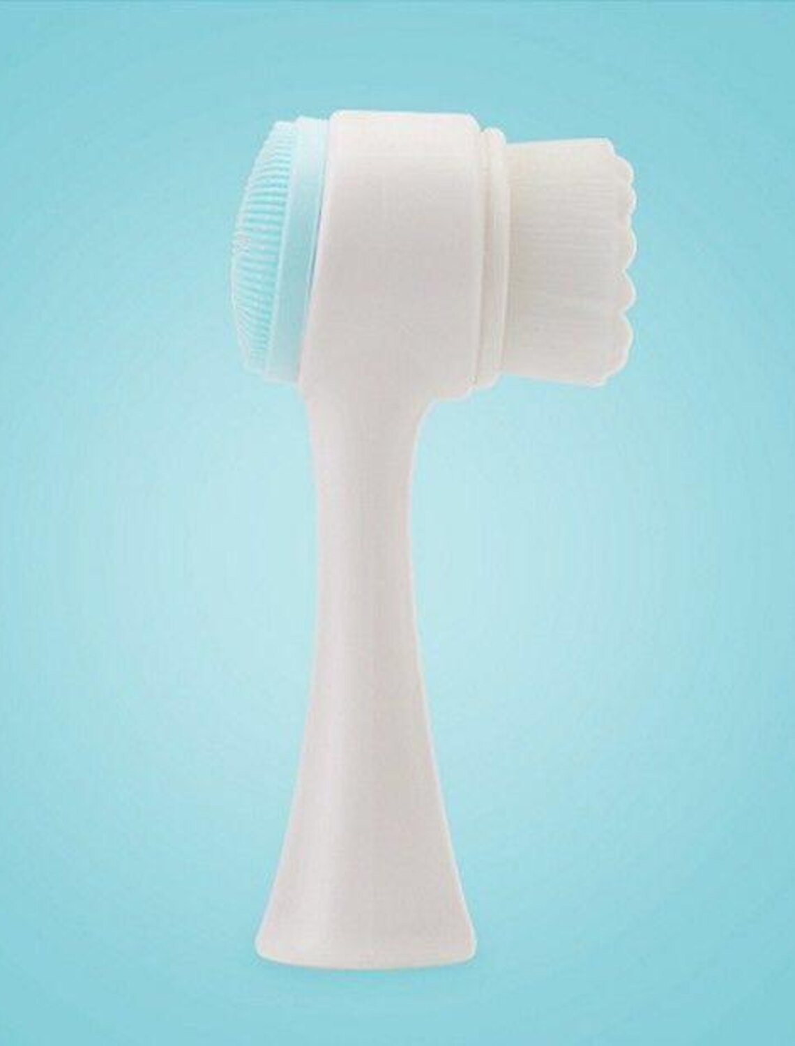 Detailed view of the massaging nubs on the back of the face brush.