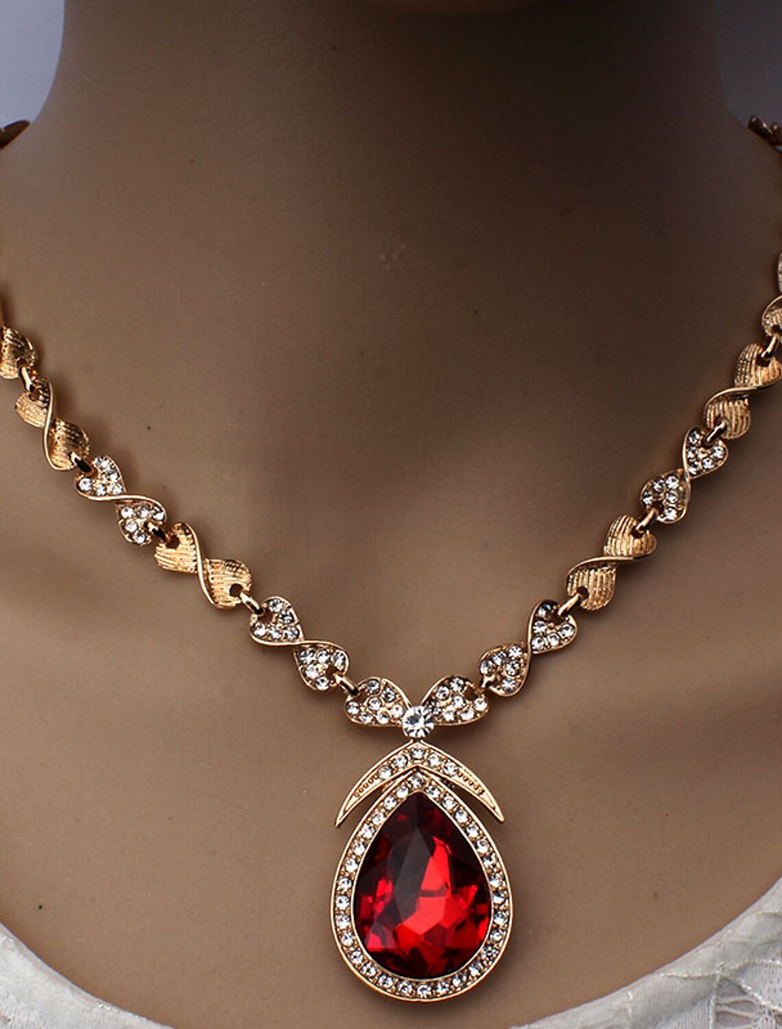 Close-up of 18K gold plated necklace with white cubic zirconia pendant.