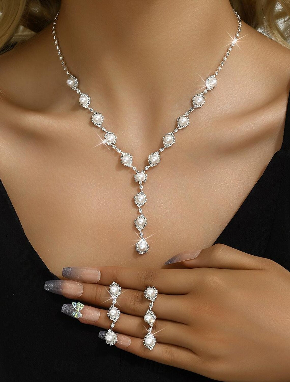 Elegant 4-piece imitation pearl and rhinestone jewelry set, including necklace, earrings, and bracelet.
