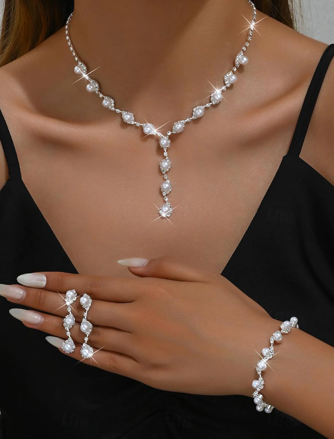 Close-up of the imitation pearl and rhinestone necklace and earrings from the jewelry set.