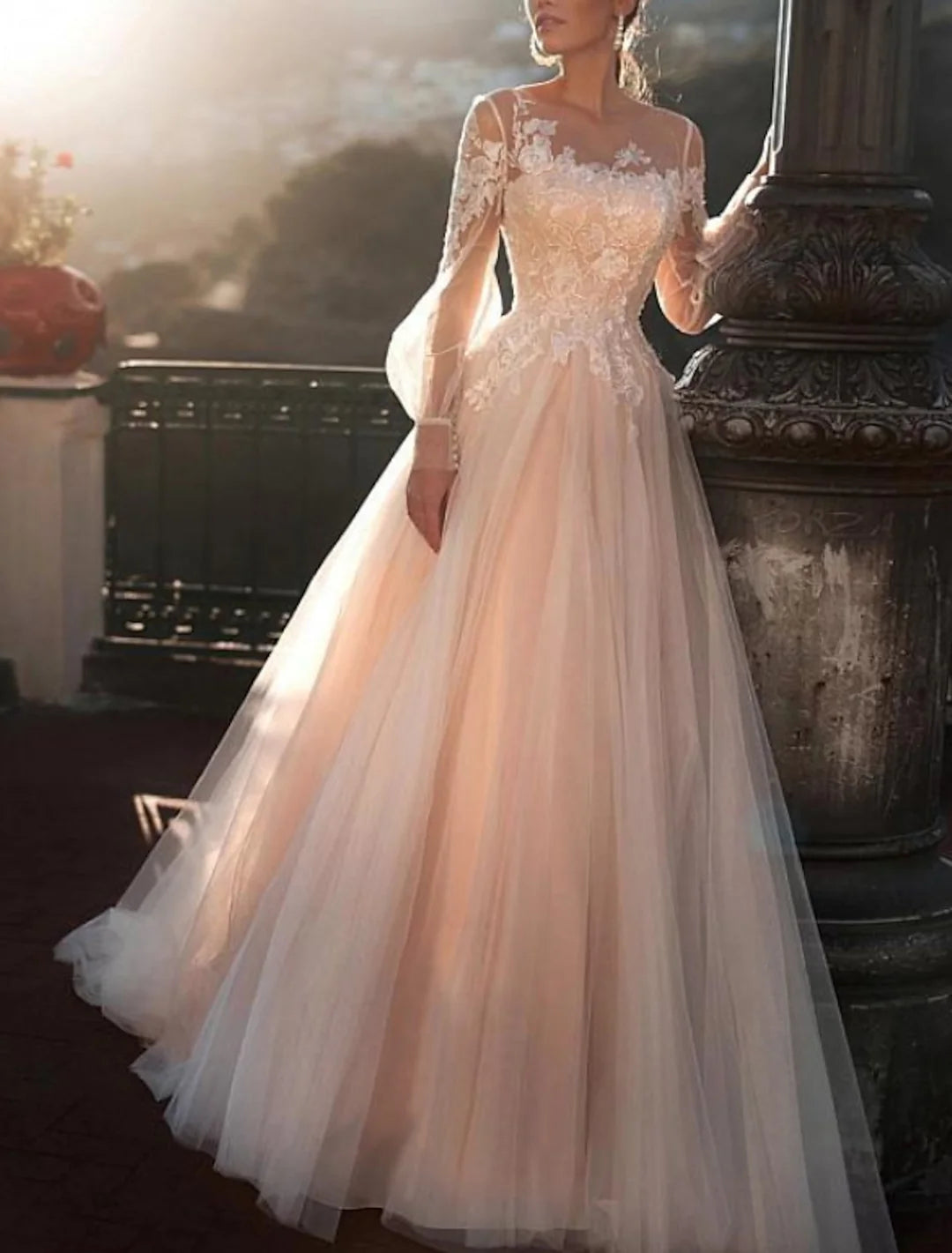 Elegant A-line beach wedding dress with appliques, worn by a bride on the sand.