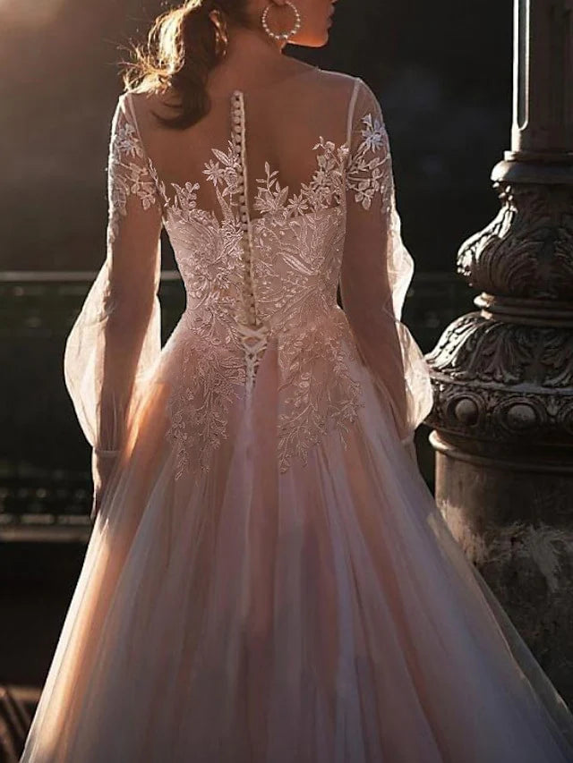 Close-up of delicate appliques on the neckline of an A-line wedding dress.