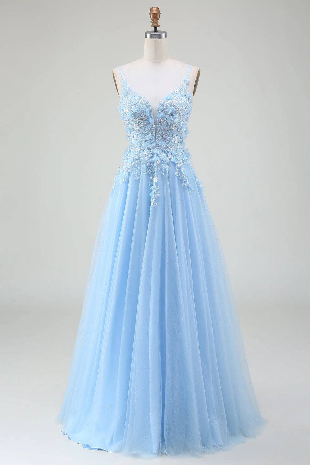 Full view of an elegant A-line light blue prom dress with intricate appliques.