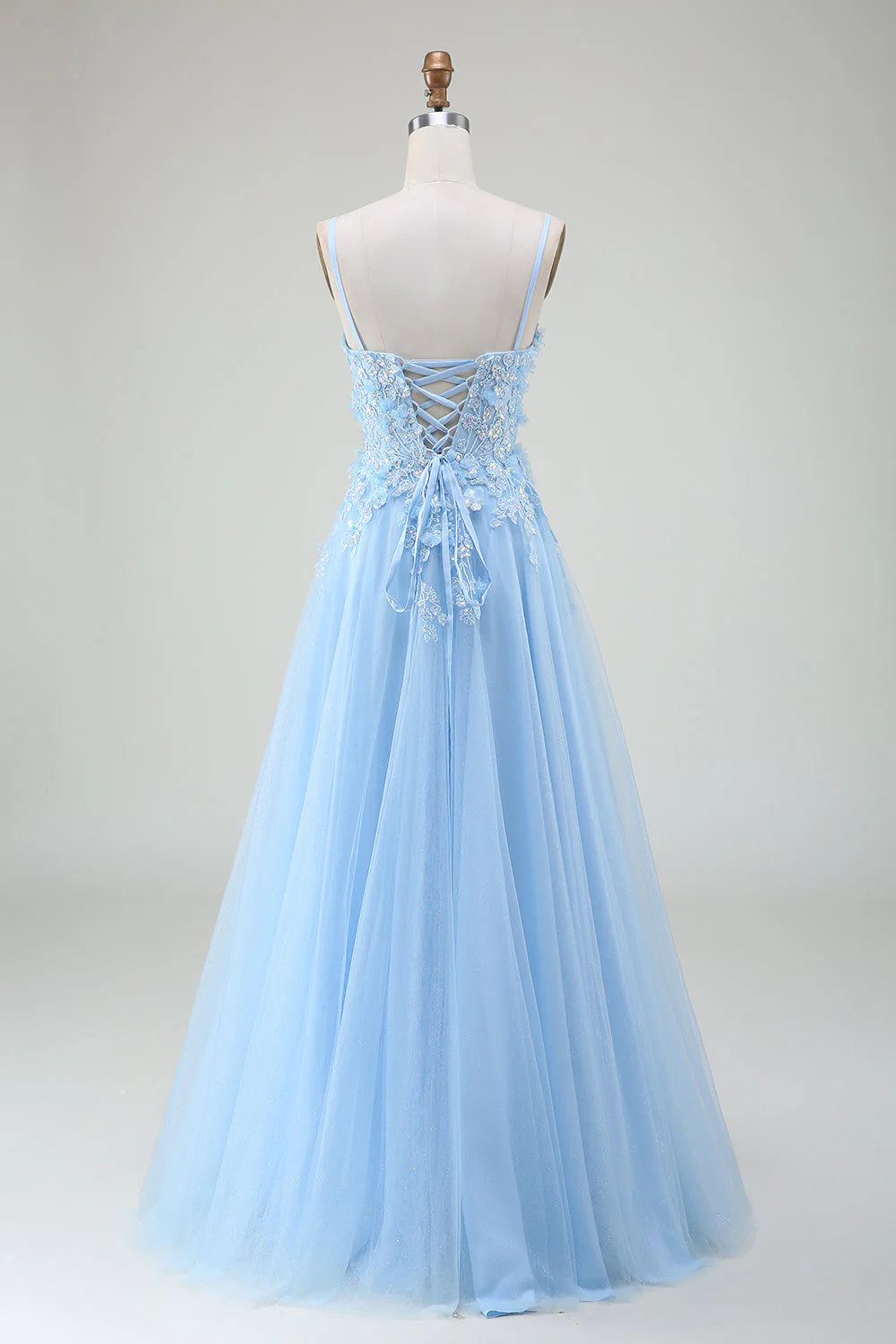 Side view of the light blue A-line prom dress, highlighting its flowing silhouette.