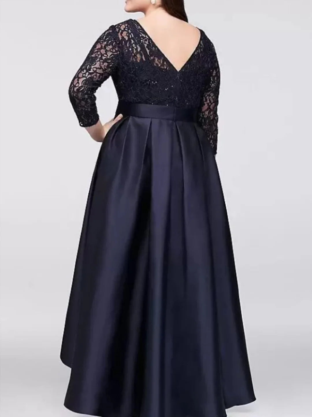 Side view of the A-line Mother of the Bride dress with delicate applique.