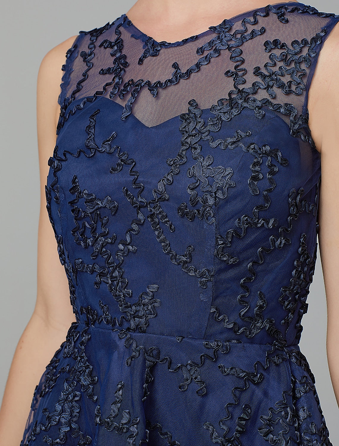Full length view of A-line wedding guest dress with tulle skirt.