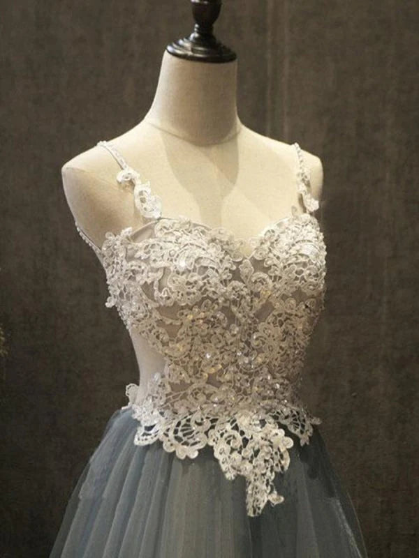 Full view of the backless design and long tulle skirt of the formal A-Line gown.