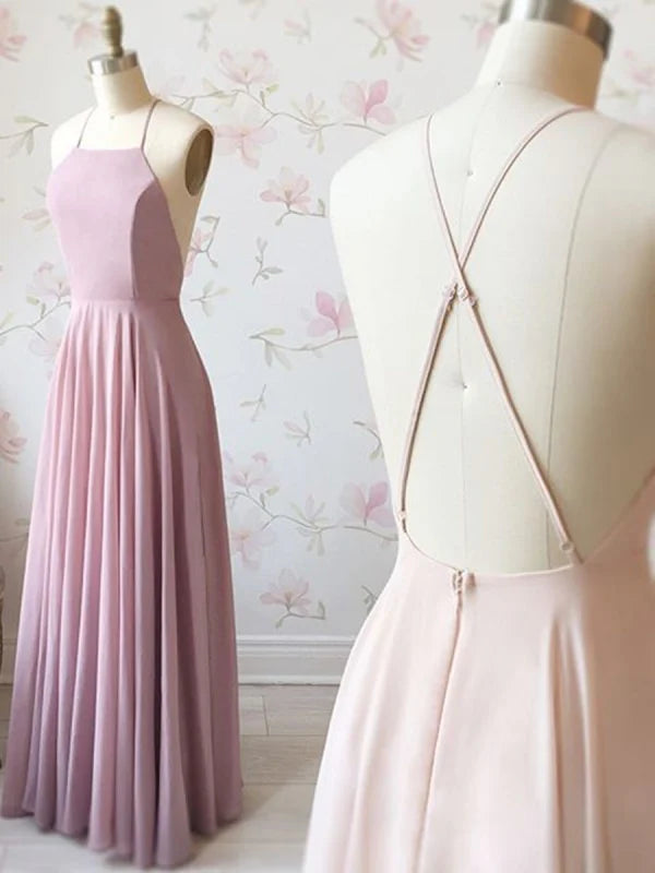 Woman wearing an elegant A-line backless long prom dress.