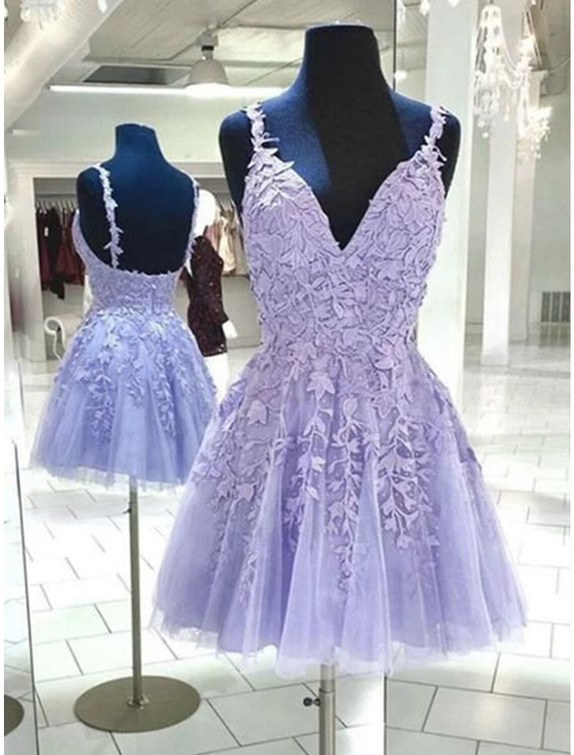 A-line backless short dress with spaghetti straps and floral appliques.