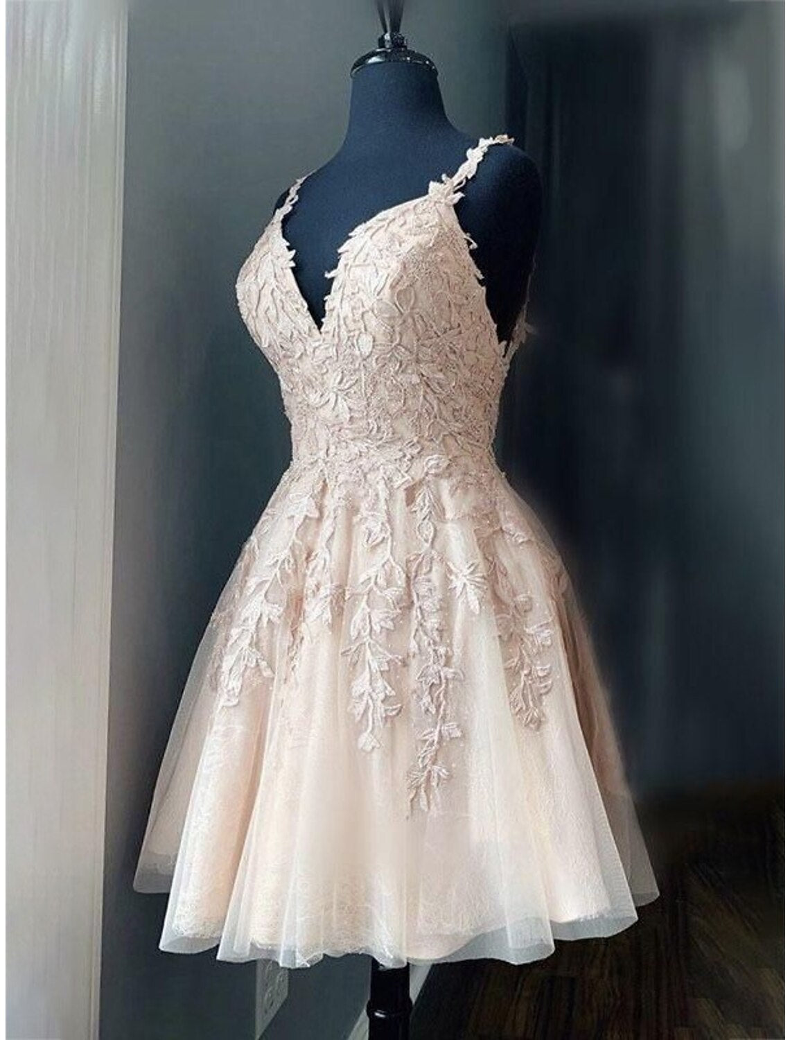 Back view of A-line short tulle dress with appliques and spaghetti straps.