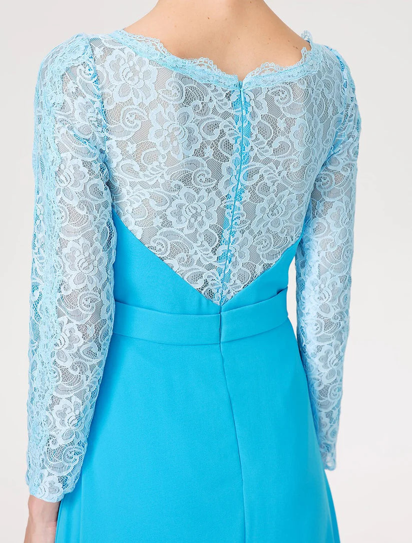 Woman in a Mother of the Bride dress, showing the full A-line silhouette and scoop neckline.