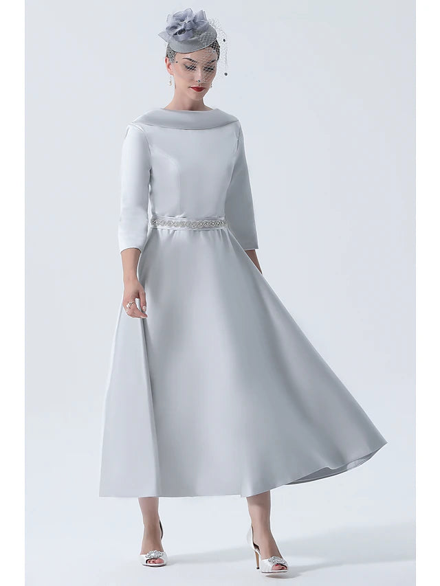 Elegant A-Line Mother of the Bride dress with bateau neck and 3/4 sleeves, adorned with beading.