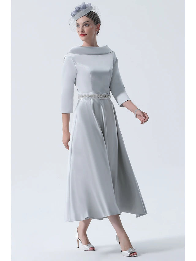 Side view of a woman wearing an A-Line tea length satin dress with beaded details.