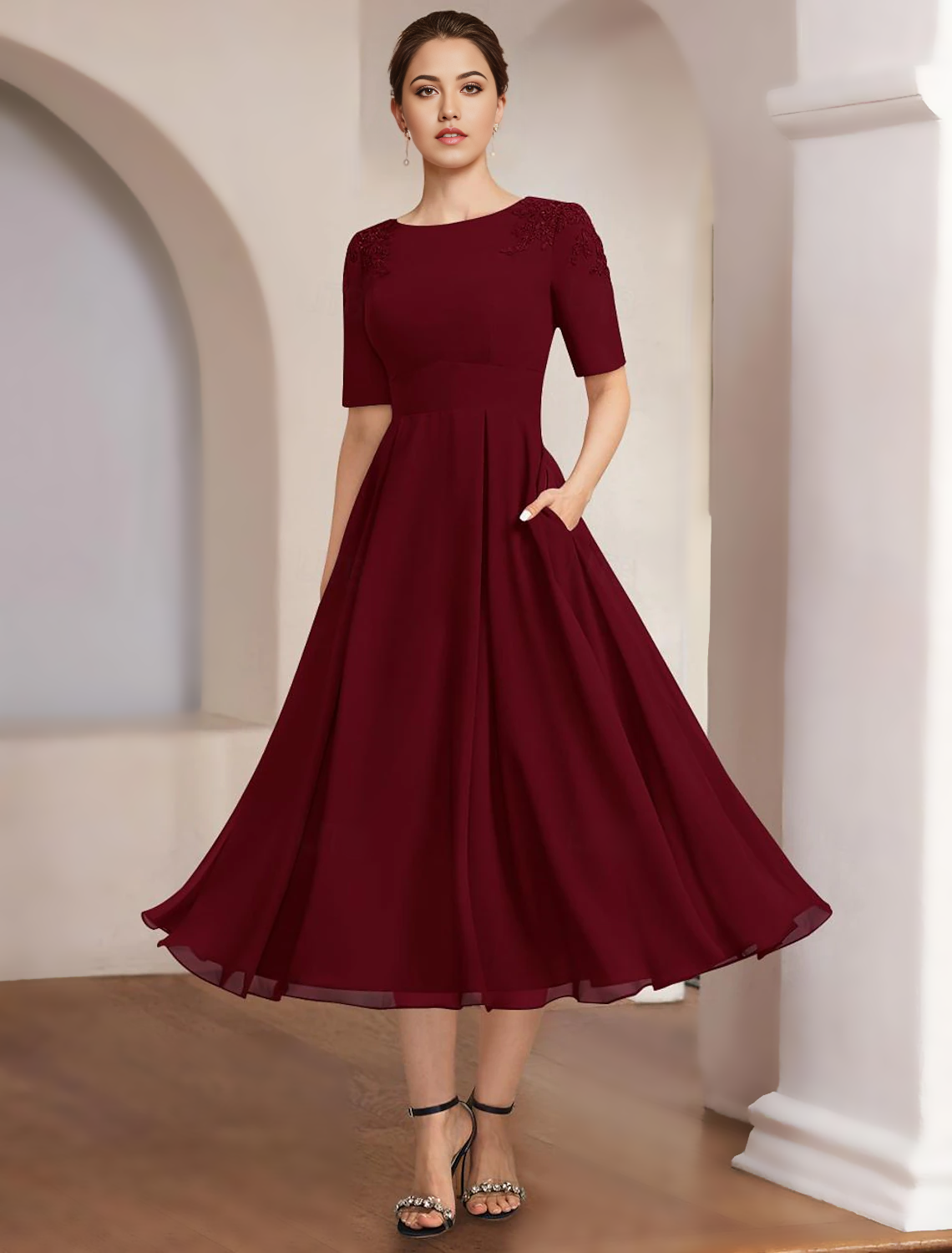 Woman posing in the elegant ankle-length Mother of the Bride dress.